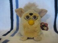 A Lamb Furby with brown eyes.