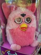A Flamingo Furby with brown eyes