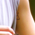 Clothes hanger on left bicep c. August 8, 2012