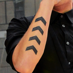 Four chevrons ›››› on right forearm c. November 7, 2012