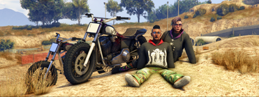 Marcie and Talia sitting with motorbikes