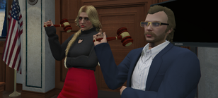 Bertrand and fellow DoJ member Liesje van Dorst posing with gavels