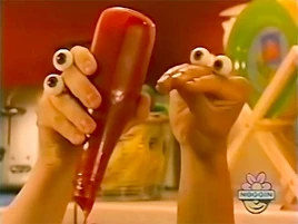 Oobi-shorts-Hot-Dog-and-Ketchup-holding-bottle