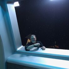 Director  sits on the exterior of the Orville's mess hall while filming this episode of The Orville.