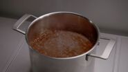 A pot of boiling trivalve sauce.