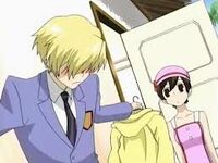 Tamaki attempts to cover up his blush as he tells Haruhi to wear a pullover.