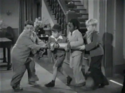 Spanky, Mickey, Buckwheat, and Froggy preparing to release canister of laughing gas into the wedding ceremony and making the guest laugh inhaling it.