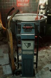The image shows a tall blue grey box with a red horizontal lever at the top, and a black Murkoff logo against a white background in the middle