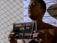 Omar preparing to have his mugshot taken.