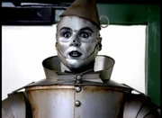 The Tin Man is surrounded by hungry children