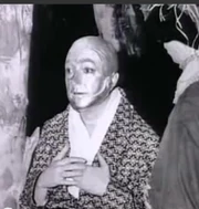 Jack Haley putting on the  Tin Man makeup