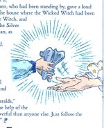 The Good Witch gives Dorothy the Silver Shoes.