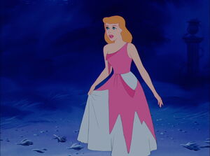 As her Fairy Godmother helps her gret ready for the ball, Cinderella waits patiently for her dress to get mended.