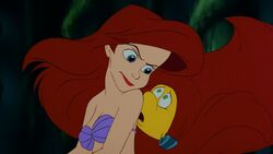 Ariel glaring at Flounder when he accidentally reveals to her father that they were up at the surface.