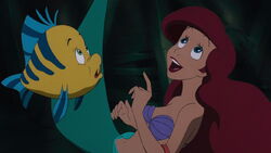Ariel and Flounder about to swim up to the second floor of the ship.