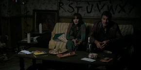 Joyce as Lonnie tells Jonathan not to worry about the hole in the wall.