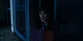 Joyce peeking outside in the rain.