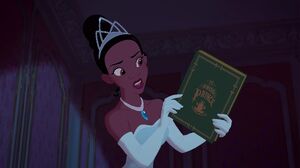 Tiana seeing Naveen is interested in the story of The Frog Prince.