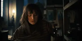 Joyce taking her shirt off to change into her new one.