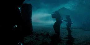 Joyce and Hopper finding and walking towards an alternate version of the Byers house in the Upside Down.