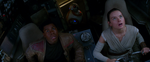 Finn and Rey look up in fright as they are caught in a tractor beam.