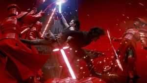 While fighting together, Rey leans into Kylo's back and grabs his thigh to support her attacks against the guards.