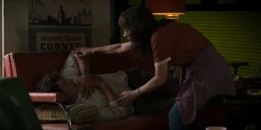 Joyce waking up Alexei, telling him they need to get back to Hawkins.