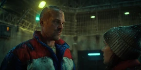 Joyce being instructed by Hopper to turn the pit's electric fence back on so the monsters won't be able to escape once they're inside.