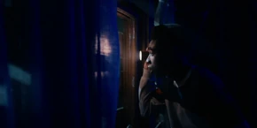 Lucas shining his flashlight to signal Erica.