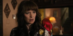 Joyce looking at the doll she just received.