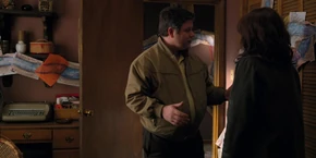 Joyce and Bob talking in private where she hears Bob express concern over her and Will's well-being.