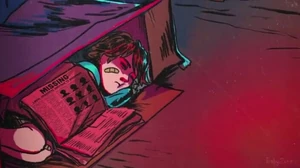 Gregory sleeping in a cardboard box.