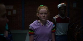 Lucas looking at Max, waiting for her response before they turn on the sauna.