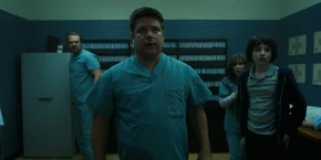 Joyce, Mike, Bob, and Hopper noticing live surveillance footage in the room they're hiding in.