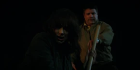 Joyce going to stab the vines with the shovel.