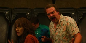 Joyce and Hopper being ordered to go against the walls of Gravitron by the ride's operator.