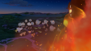 Scar looks down at the pride landers after his success in setting pride rock on fire.