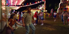 Joyce and Hopper entering another part of the fair after going through some carnival games.