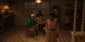 Lucas and Dustin hearing Erica say she thinks Vecna is in the Upside Down version of the Wheeler house.