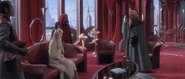 Panaka watching Queen Amidala converse with Senator Palpatine.