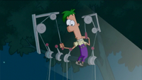 Ferb operating the puppets in the tree.