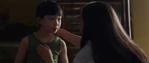 Shang-Chi being gifted a green pendant from his mother.