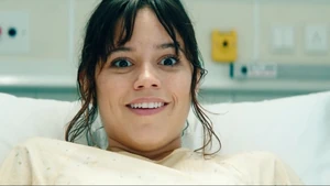 Astrid giggling manically as she looks at her demonic infant in Lydia's nightmare.