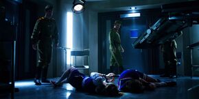 Steve and Robin having been taken to an interrogation room as they lay on the ground.