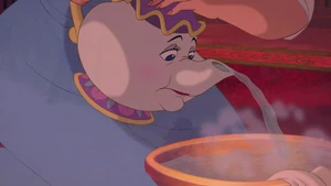 Mrs. Potts pouring hot water into a bowl for Belle to use in order for her to clean Beast's wounds that he sustained when saving her from a pack of wolves.