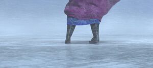 Anna barely slipping while walking through the blizzard.