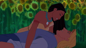 John and Pocahontas in a sunflower meadow.