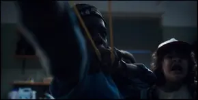 Lucas going to fire another rock at the Demogorgon as it advances towards him and his friends.