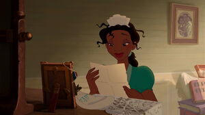 Tiana looking at the restaurant poster her father gave to her.