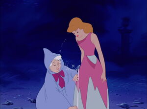 The Fairy Godmother measuring Cinderella's size in order to get an idea on what kind of dress she should wear.